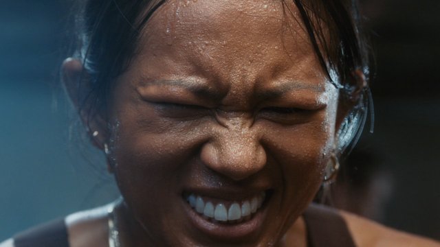 Video Reference: close-up, face, expression, grimace, strain, effort, sweat, eyes closed, teeth, emotion, portrait, intense, dramatic, human