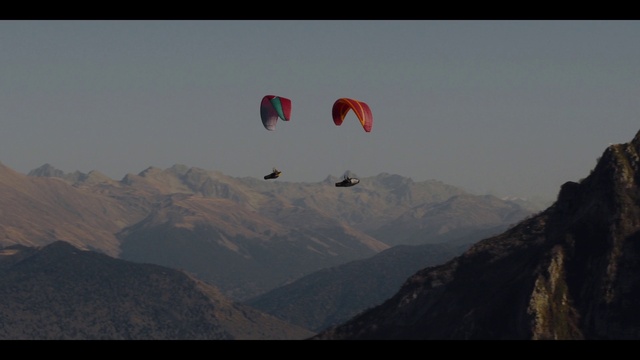 Video Reference: Sky, Mountain, Parachute, Paragliding, Highland, Parachuting, Cloud, Atmospheric phenomenon, Slope, Terrain
