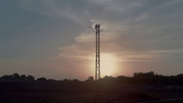Video Reference: Cloud, Sky, Atmosphere, Ecoregion, Tower, Electricity, Dusk, Sunlight, Afterglow, Sunset