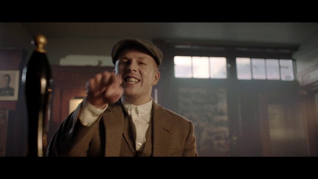 Video Reference: Flash photography, Coat, Hat, Gesture, Window, Tie, Dress shirt, Suit, Smile, Cap