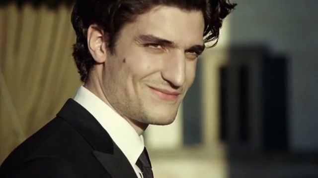 Video Reference: Forehead, Smile, Lip, Hairstyle, Eyebrow, Coat, Flash photography, Jaw, Eyelash, Neck