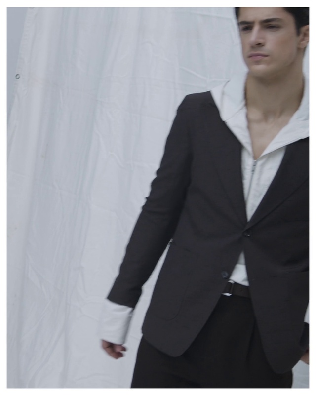 Video Reference: Dress shirt, Neck, Sleeve, Street fashion, Gesture, Collar, Grey, Fashion design, Blazer, Formal wear