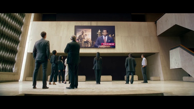 Video Reference: Coat, Entertainment, Stage, Suit, Performing arts, Display device, Event, Stage equipment, Chair, Art