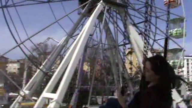 Video Reference: Sky, Ferris wheel, Vehicle, Recreation, Mast, Rim, Leisure, Pole, Event, Wheel