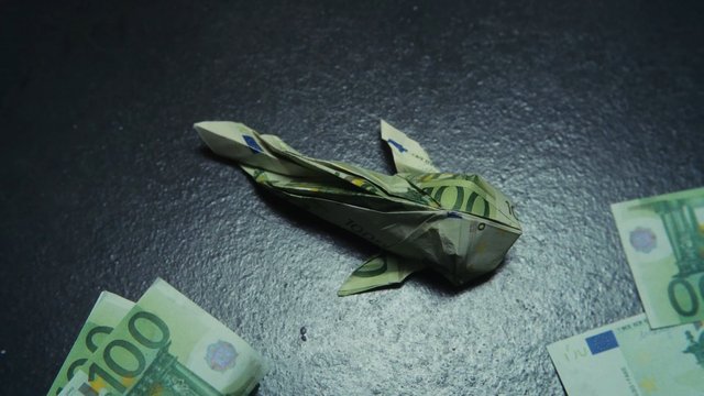 Video Reference: origami, banknotes, euros, money, paper craft, folded cash, close-up, still life, dark background, finance, currency, handmade, tabletop, art, abstract, macro