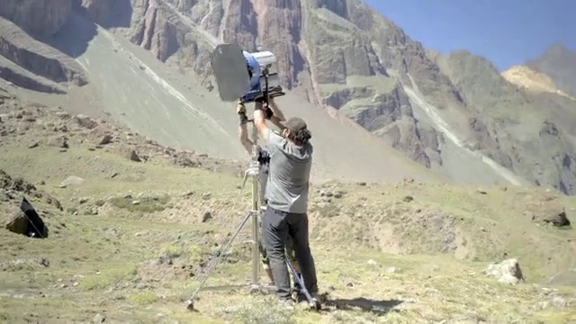 Video Reference: Mountain, Sky, Ecoregion, Slope, Highland, Outdoor recreation, Terrain, Grass, Grassland, Hiking equipment