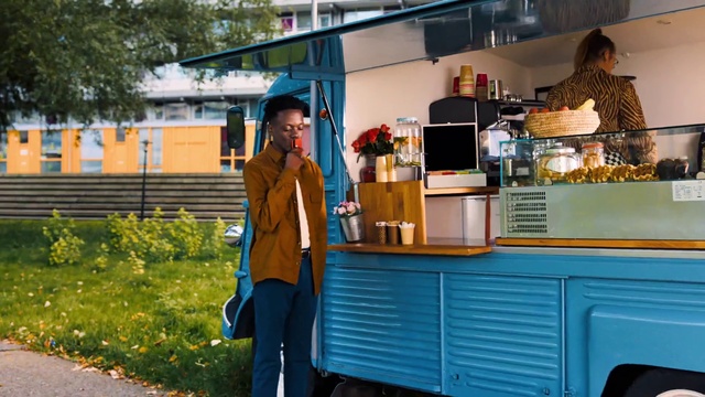 Video Reference: Plant, Food, Tire, Vehicle, Wheel, Orange, Tree, Yellow, Building, Food truck