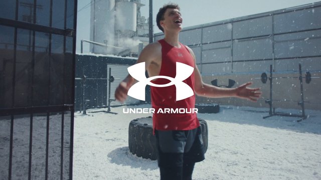 Video Reference: athlete, fitness, workout, snow, outdoor gym, training, smiling, sleeveless shirt, sportswear, winter, exercise, weights, strongman, brand logo, commercial, portrait