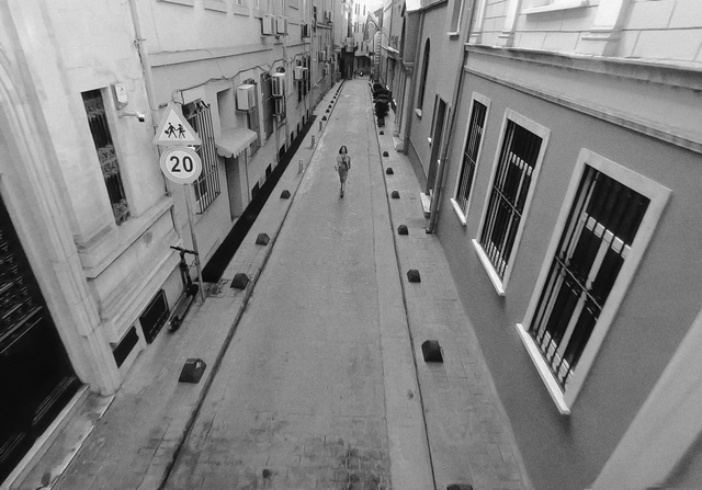 Video Reference: Black, Black-and-white, Building, Style, Window, Neighbourhood, City, Road, Symmetry, Parallel