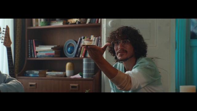 Video Reference: Shelf, Bookcase, Gesture, Shelving, Flash photography, Happy, Display device, Electronic device, Television set, Eyewear
