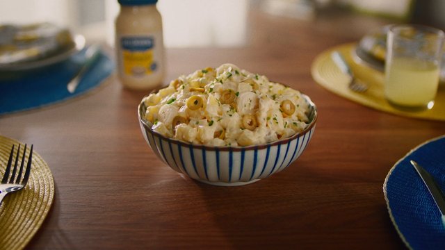 Video Reference: pasta salad, food, bowl, olives, herbs, table setting, dining table, homemade, creamy, close-up, meal, lunch, kitchen, dishware, centerpiece, plate