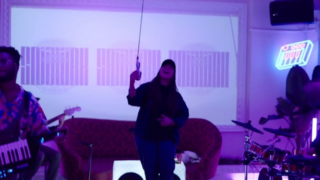 Video Reference: Microphone, Musical instrument, Purple, Musician, Plant, Public address system, Entertainment, Music artist, Music, Performing arts