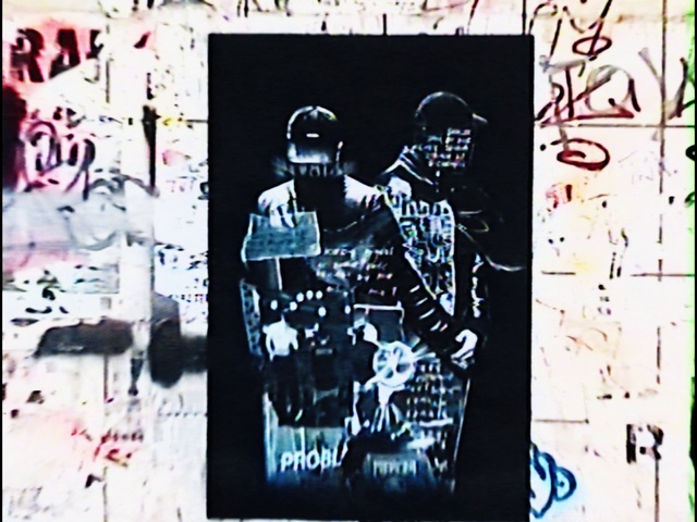 Video Reference: Black, Sleeve, Rectangle, Font, Gesture, Art, Wall, Graffiti, T-shirt, Poster