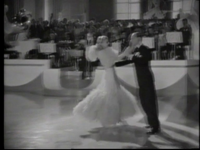 Video Reference: Wedding dress, Dress, Bridal clothing, Flash photography, Bride, Dance, Bridal party dress, Black-and-white, Gesture, Happy