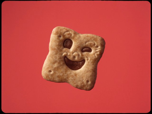 Video Reference: biscuit, cookie, smiling, food, snack, square, red background, studio shot, isolated, close-up, confectionery, cute, face shape
