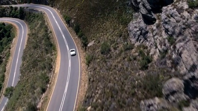 Video Reference: Plant, Vehicle, Road surface, Asphalt, Car, Motor vehicle, Slope, Tree, Landscape, Thoroughfare