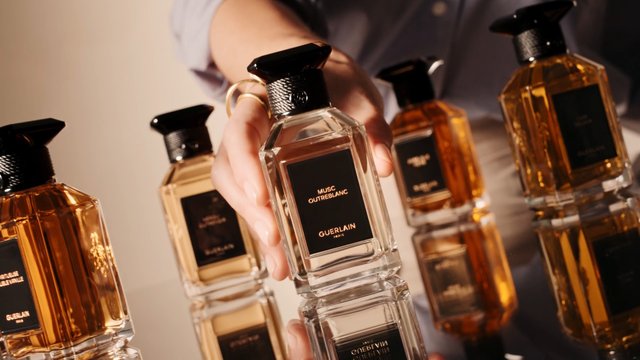 Video Reference: perfume, fragrance, bottle, luxury, cosmetics, glass, amber, hand, product shot, reflection, beauty, advertising
