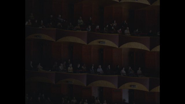 Video Reference: theater, audience, balcony, concert hall, seating, interior, crowd, dark, performance venue, architecture