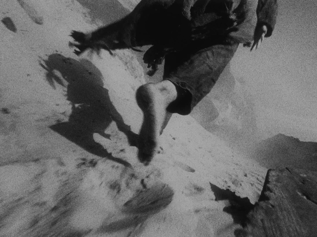 Video Reference: Shorts, Gesture, Grey, Style, People in nature, Black-and-white, Tints and shades, Geological phenomenon, Landscape, Human leg