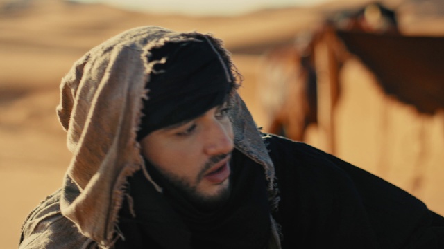 Video Reference: Outerwear, Eyebrow, Flash photography, Beard, Happy, Cap, Headgear, Audio equipment, Black hair, Jacket