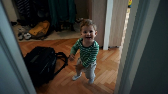 Video Reference: Smile, Wood, Standing, Flooring, Floor, Baby & toddler clothing, Hardwood, Toddler, Luggage and bags, Baby