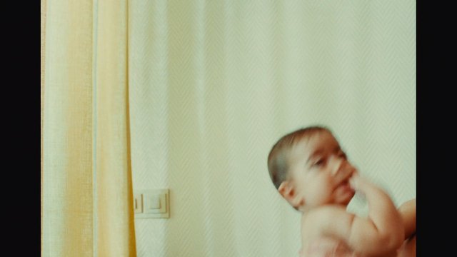 Video Reference: baby, infant, child, indoor, portrait, blurred, motion, wall, curtain, home, close-up