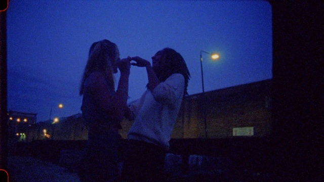 Video Reference: Sky, Light, Street light, Flash photography, Kiss, Gesture, Midnight, Electric blue, Darkness, Entertainment