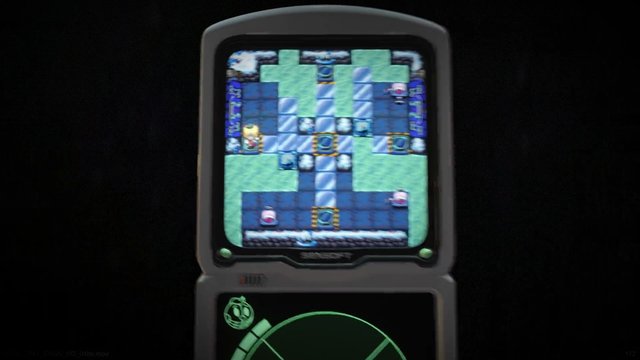 Video Reference: handheld console, video game, dual screen, pixel art, maze, puzzle, retro game, screen close-up, gaming device, top-down view, radar interface, dark background