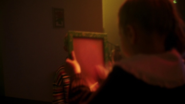 Video Reference: Gesture, Eyewear, Wood, Fun, Facial hair, Picture frame, Event, T-shirt, Magenta, Darkness