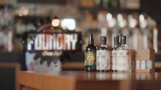 Video Reference: Drinking establishment, Bottle, Drinkware, Barware, Glass bottle, Liquid, Alcoholic beverage, Wood, Drink, Table