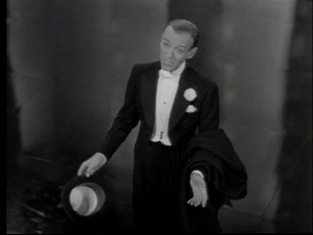 Video Reference: Suit trousers, Coat, Flash photography, Gesture, Black-and-white, Suit, Blazer, Collar, Tie, Formal wear