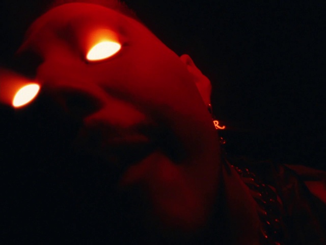 Video Reference: Lip, Entertainment, Facial hair, Beard, Magenta, Event, Vegetable, Darkness, Carmine, Electric blue