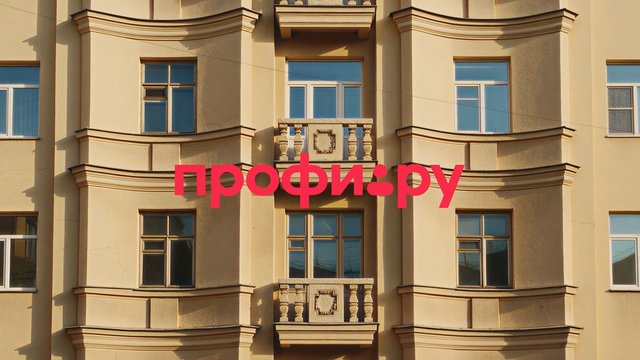 Video Reference: building, facade, apartment, windows, balconies, architecture, residential, sunlight, exterior, urban, text overlay, Cyrillic, pink text, wall, symmetry