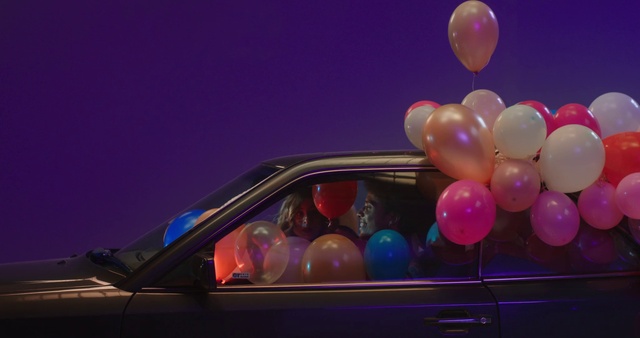 Video Reference: Window, Car, Vehicle, Hood, Balloon, Sky, Automotive lighting, Pink, Toy, Automotive mirror