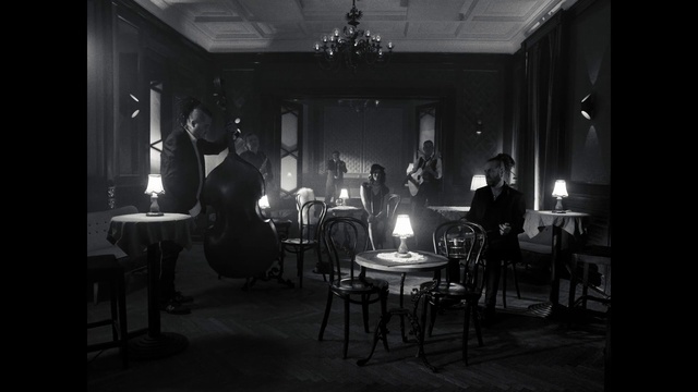 Video Reference: Furniture, Chair, Table, Standing, Black-and-white, Entertainment, Style, Musician, Flash photography, Suit