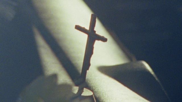 Video Reference: Cross, Sky, Religious item, Gas, Tints and shades, Symbol, Font, Art, Darkness, Electric blue