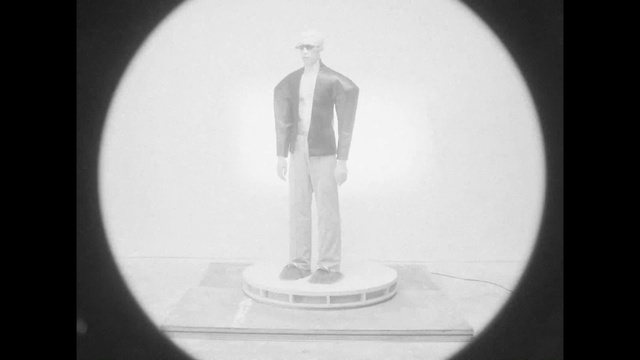 Video Reference: Leg, Sleeve, Gesture, Audio equipment, Blazer, Font, Art, Tie, Circle, Formal wear