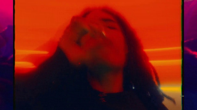 Video Reference: Lip, Jaw, Neck, Orange, Gesture, Flash photography, Entertainment, Tints and shades, Sky, Heat