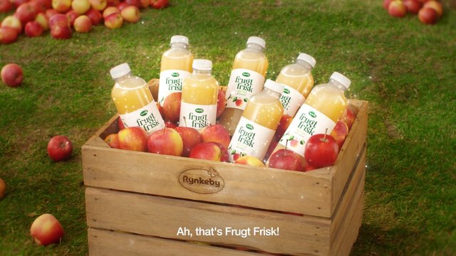 Video Reference: fruit juice, apples, wooden crate, bottles, grass, farm, orchard, produce, beverage, packaging, fresh fruit, outdoor, still life, advertisement
