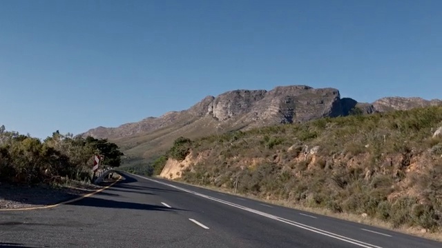Video Reference: Sky, Plant community, Plant, Mountain, Natural landscape, Road surface, Asphalt, Bedrock, Highland, Tar