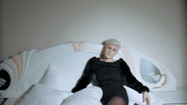 Video Reference: Hairstyle, Shoulder, Couch, Leg, Comfort, Dress, Human body, Flash photography, Neck, Sleeve