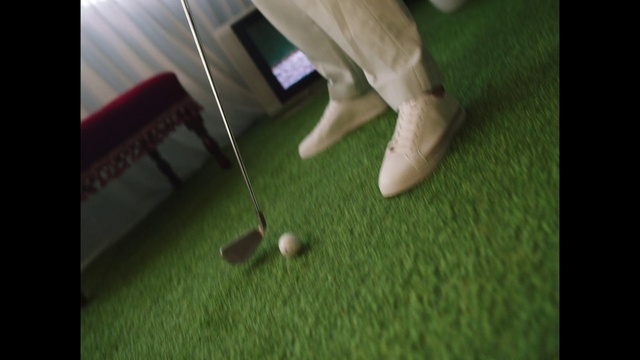 Video Reference: Golf, Golf equipment, Sports equipment, Ball, Wood, Flooring, Knee, Grass, Finger, Golf ball