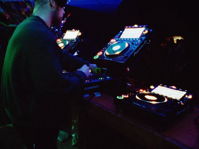 Video Reference: DJ, nightclub, music, turntable, mixing console, Pioneer, audio equipment, performance, dance music, club lighting, electronics, entertainment, live event