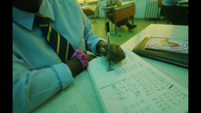 Video Reference: Green, Chair, Table, Room, Writing, Job, Font, Flooring, Child, Education