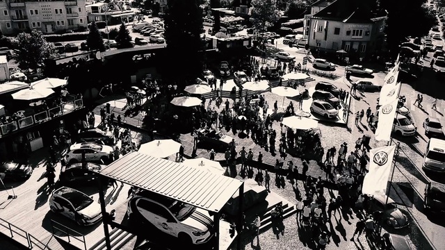 Video Reference: Motor vehicle, Infrastructure, Car, Table, Black-and-white, Urban design, Mode of transport, Style, Tent, Chair