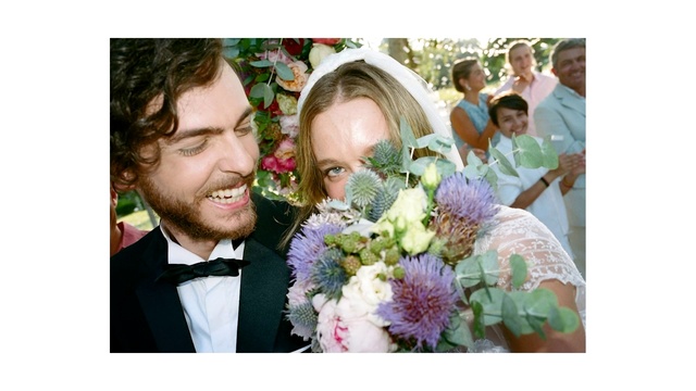 Video Reference: Flower, Smile, Facial expression, Purple, Happy, Bridal clothing, Petal, Gesture, Flower Arranging, Bride