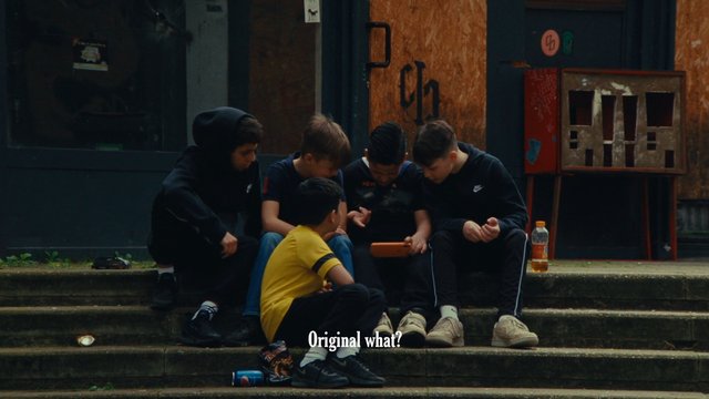 Video Reference: boys, children, teenagers, steps, outdoors, group, phone, sitting, conversation, casual, urban, subtitles, street, hoodie, social