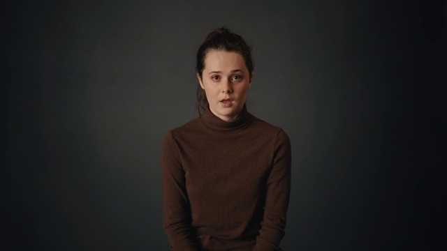 Video Reference: Cheek, Chin, Flash photography, Sleeve, Grey, Darkness, T-shirt, Sitting, Long-sleeved t-shirt, Elbow