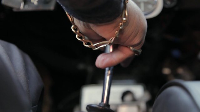 Video Reference: close-up, hand, bracelet, tool, grip, metal, mechanical, work, detail, dark-background, human, manual, equipment