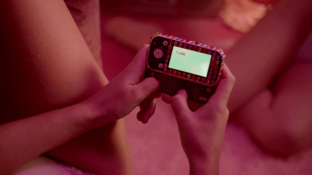 Video Reference: Hand, Gesture, Gadget, Finger, Pink, Wrist, Communication Device, Nail, Font, Measuring instrument